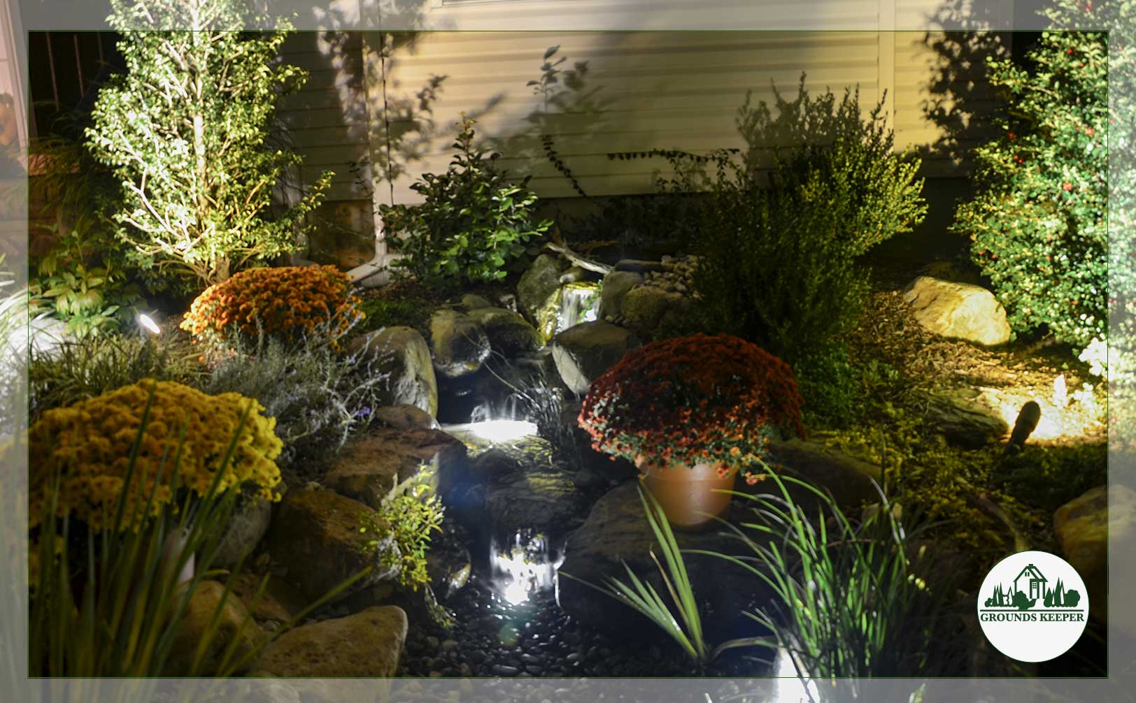 fall pond and waterfall with mums