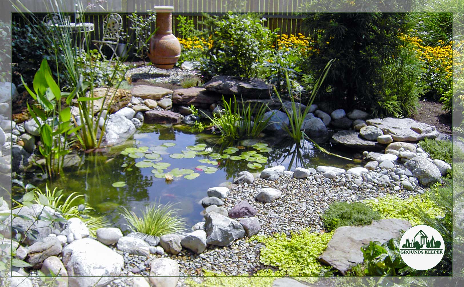 pond with gravel foreground and urn behind