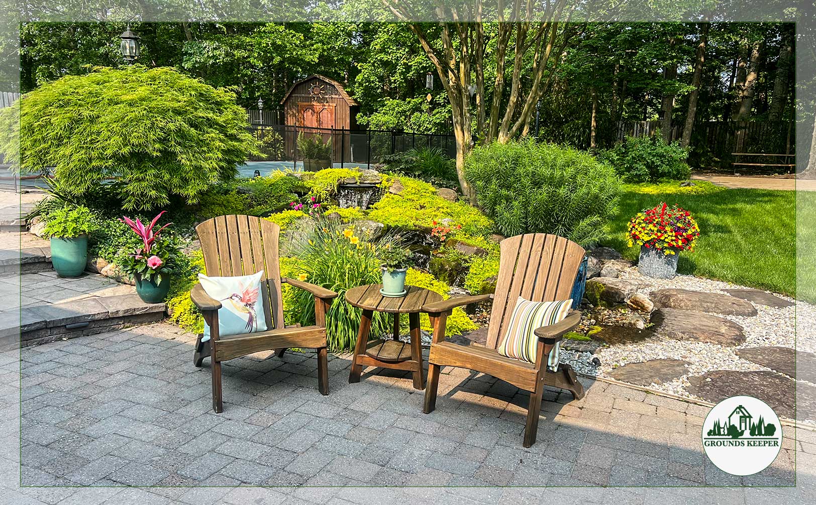 adirondack chairs on patio with pool and water feature