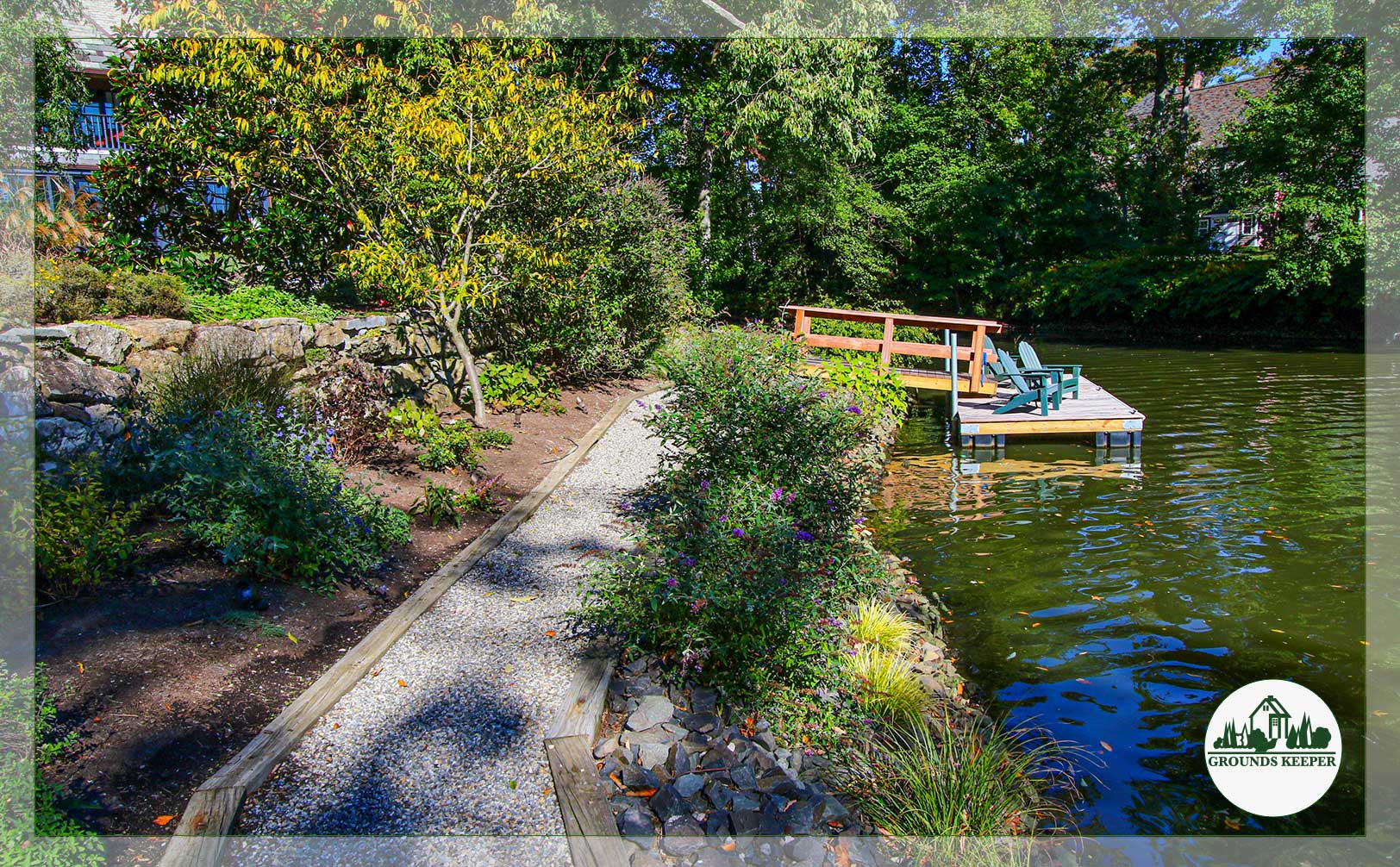 landscaping near lake with dock and chairs