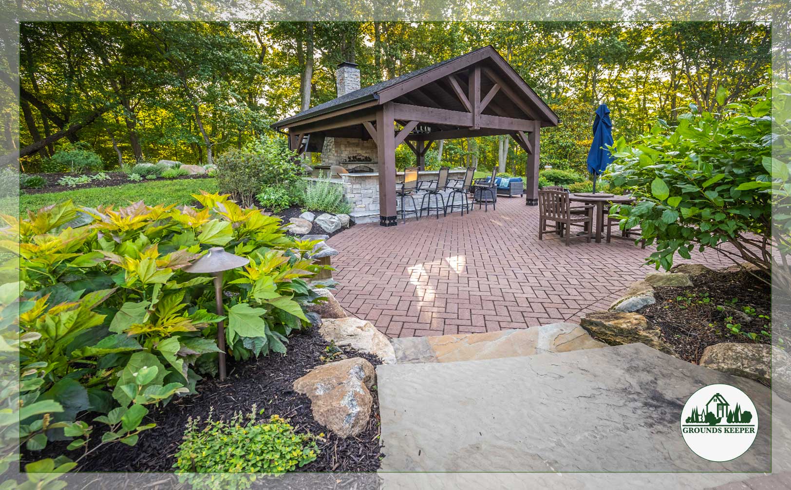 covered grill with patio walkway and landscaping