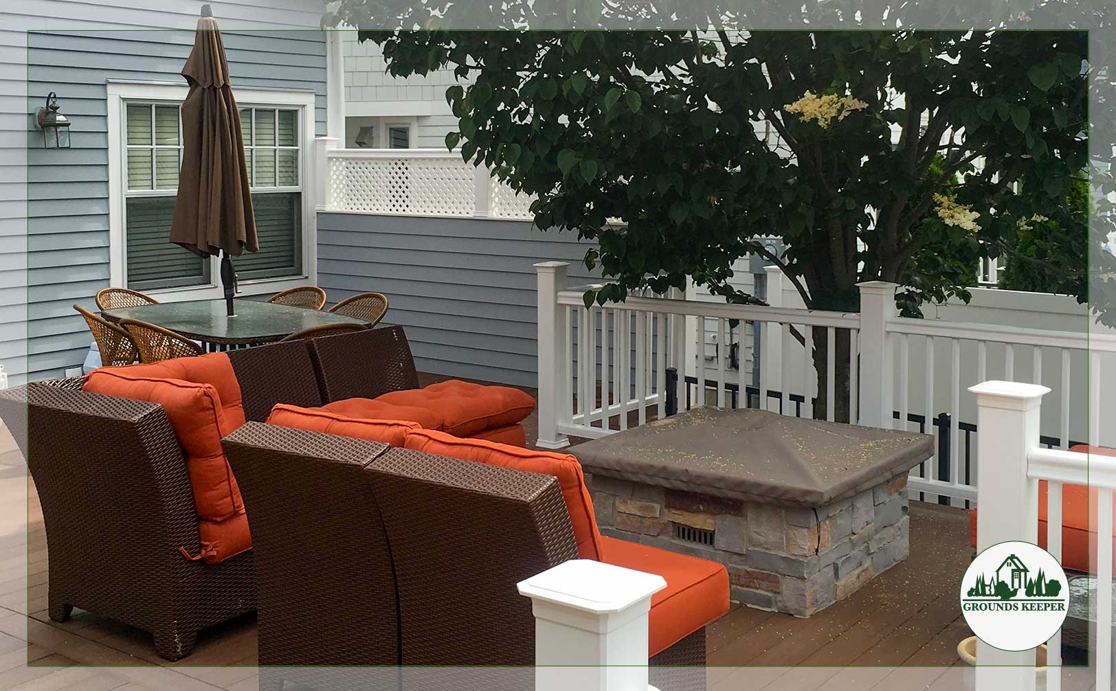 orange cushioned seating around fire pit in small back yard 