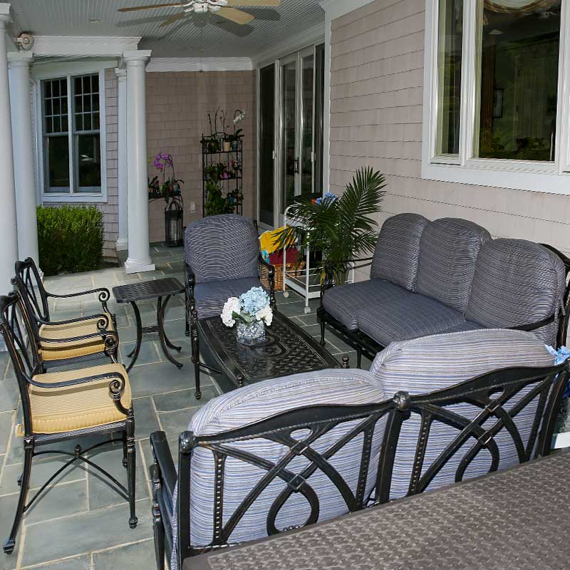 covered seating area with gray and yellow chairs