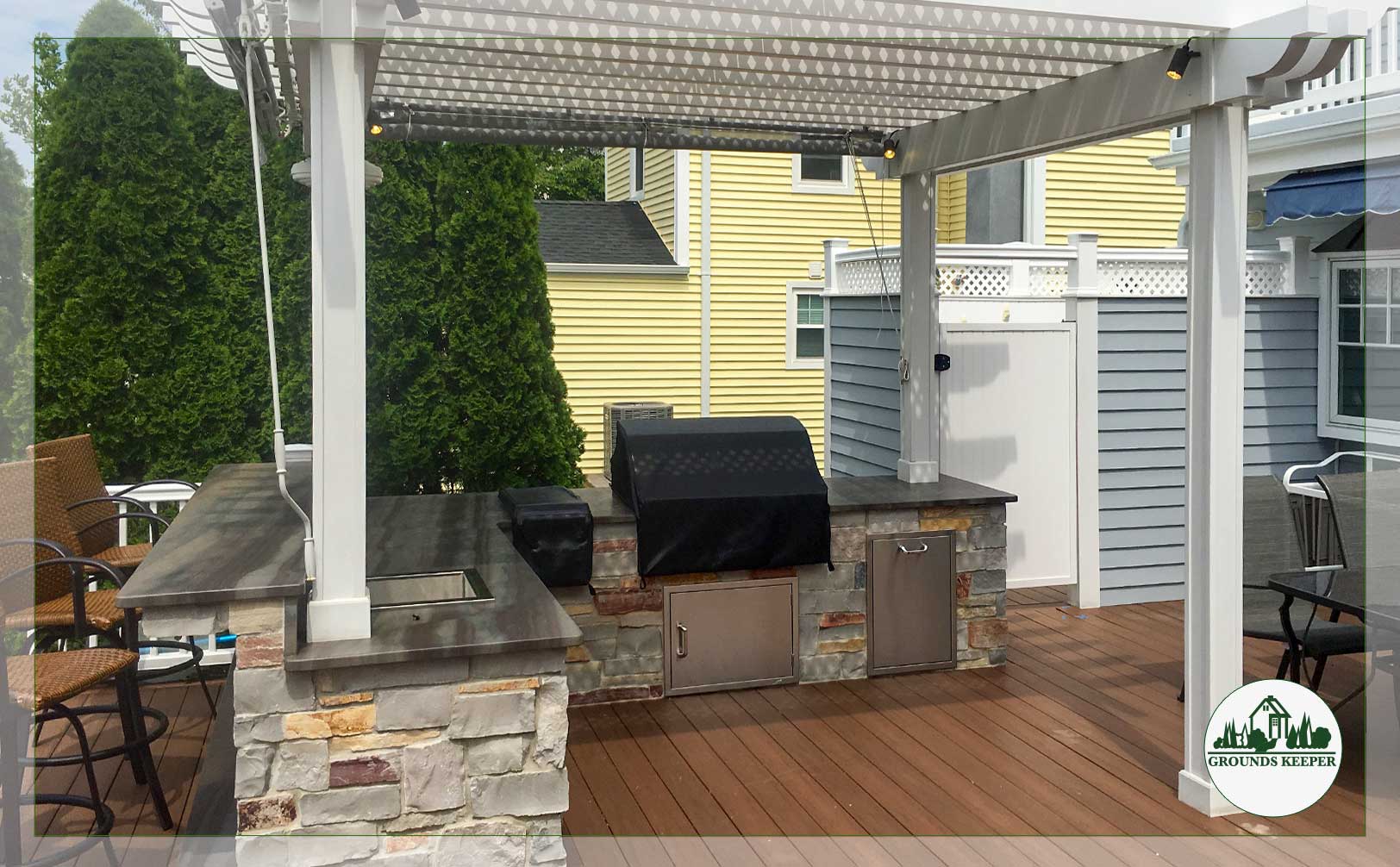 kitchen under pergola with natural stone