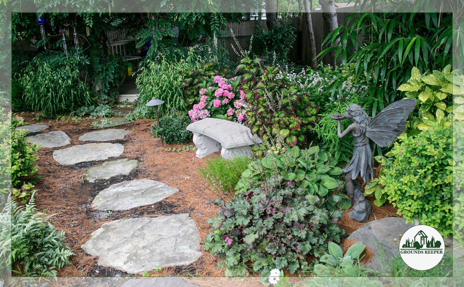naturalistic garden with stepping stones and stone fairy statue