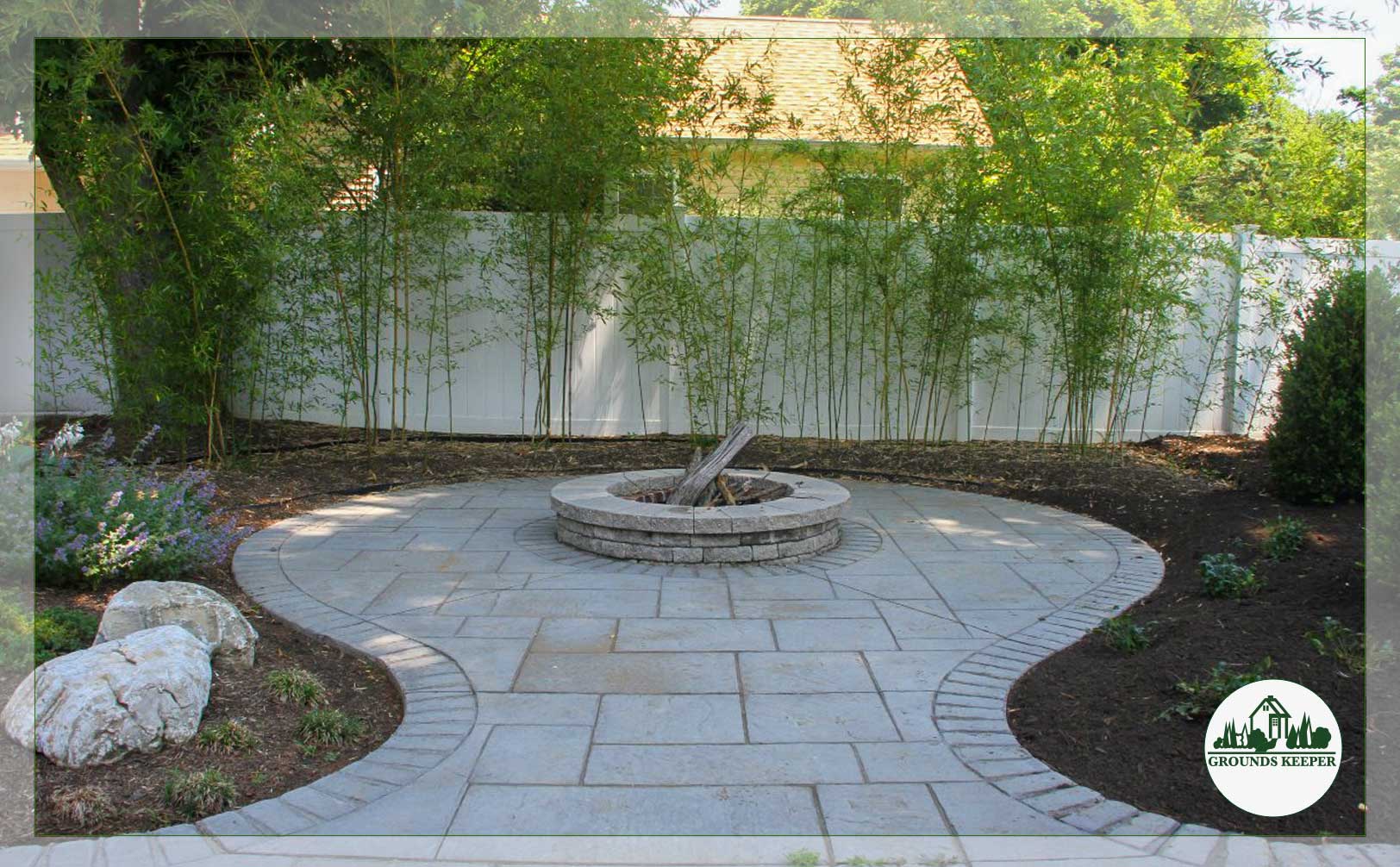 small stone patio fire pit with bamboo backdrop 