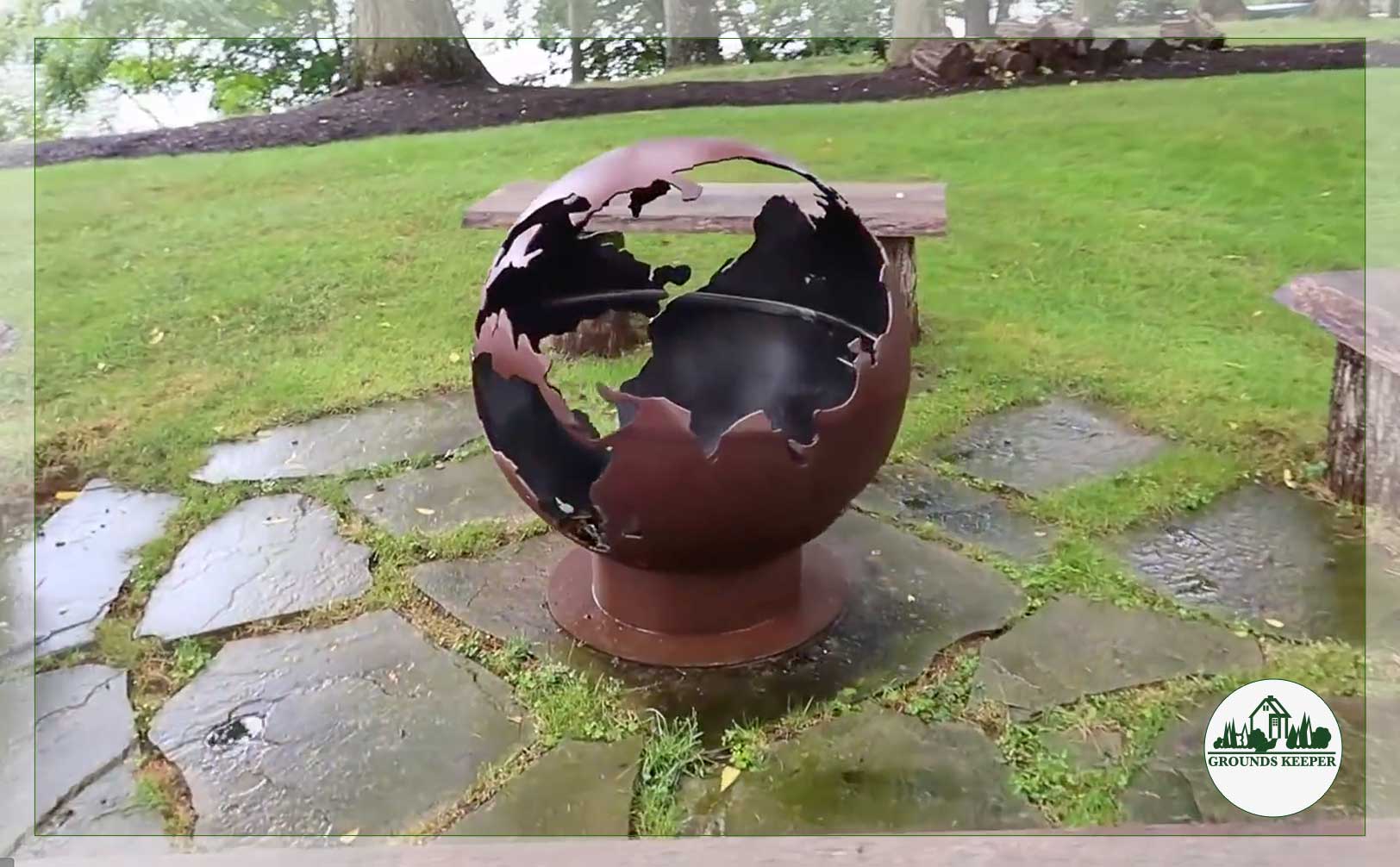 landscape in rain with globe sculpture on stone patio 