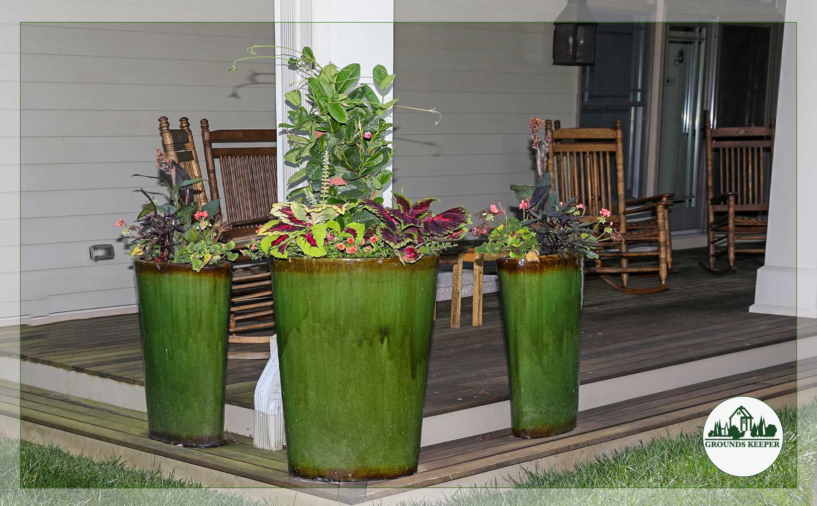 colorful foliage in planters on porch with rocking chairs