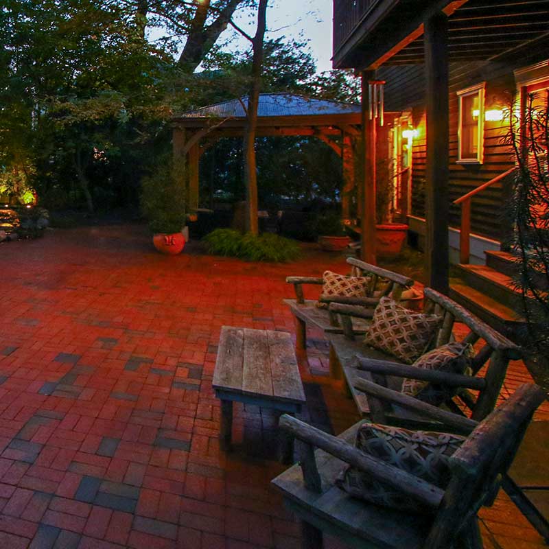 patio with small overhang and natural wood furniture